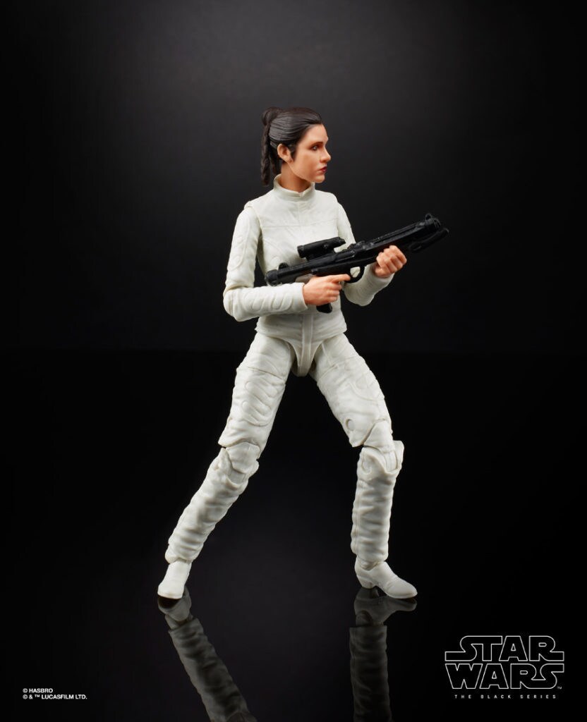 A Princess Leia Star Wars Hasbro action figure, in a white jumpsuit holding a blaster.