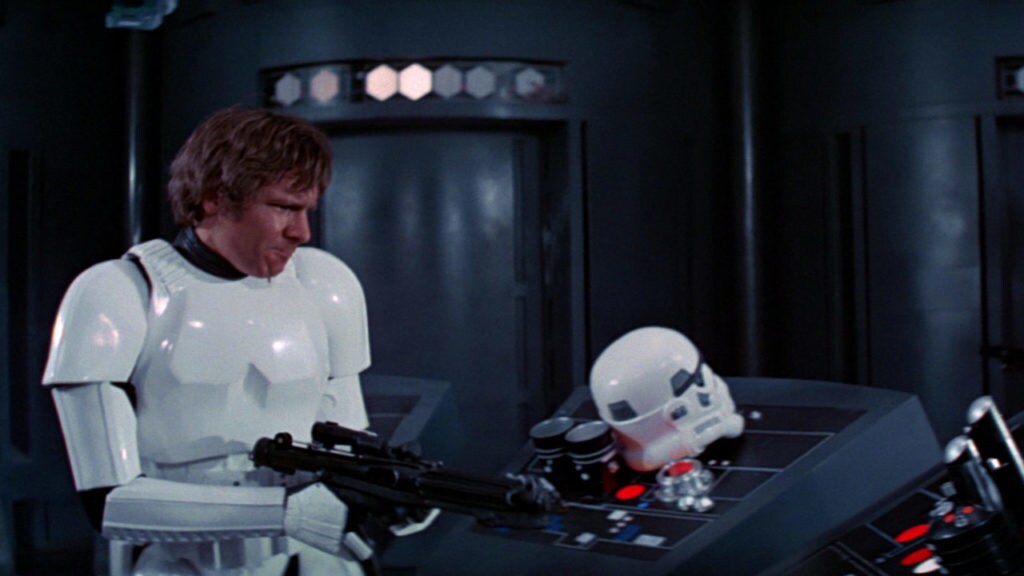 Han, wearing stormtrooper armor with no helmet, blasts a control board on the Death Star.