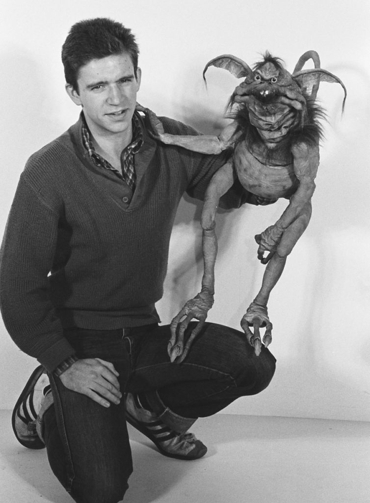 Puppeteer Tim Rose crouches as he holds Salacious Crumb.