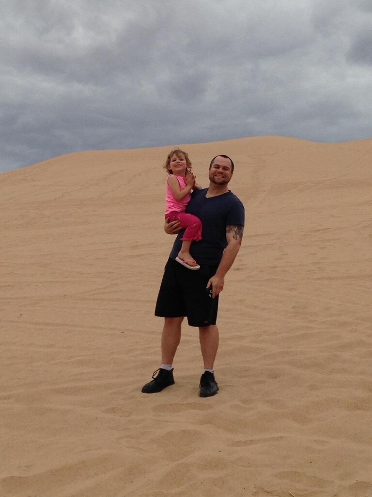 Mike DeRose holds his daughter in the sand dunes near Yuma, Arizona used for the setting of Tatooine.