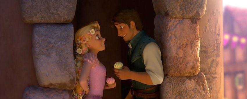 Rapunzel and Flynn Rider stand in a doorway with cupcakes.