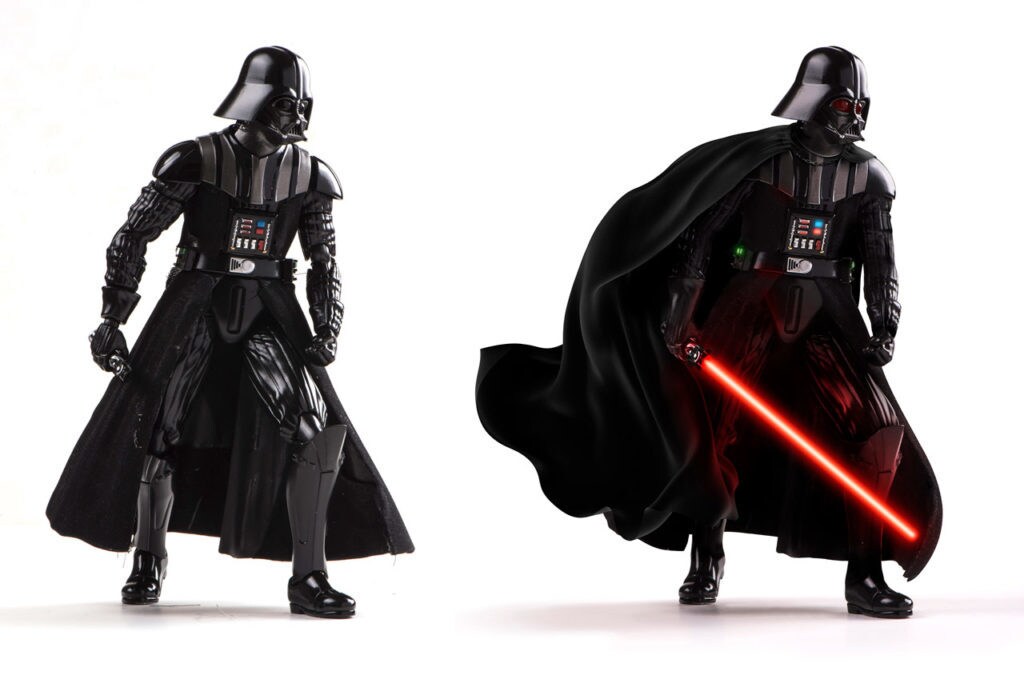 Two Darth Vader figurines, one with an ignited lightsaber.