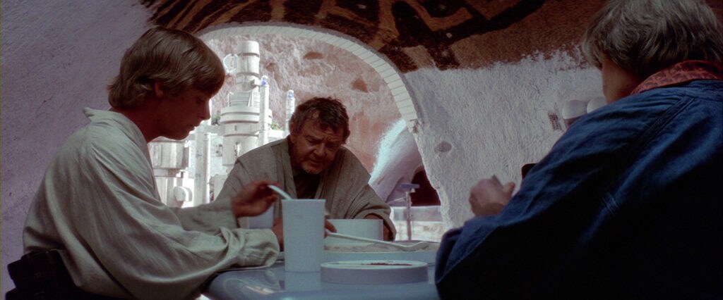 Luke eats dinner with his Uncle Owen and Aunt Beru in their home on Tatooine in A New Hope.