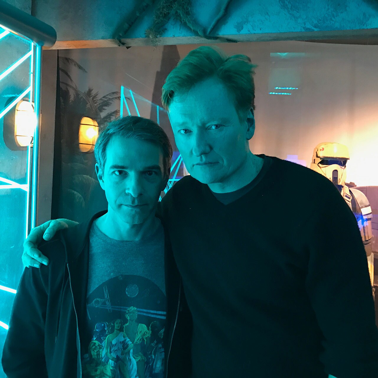 Conan O'Brien stands with his arm around TV producer Jordan Schlansky.