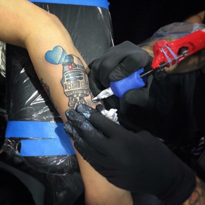 Amanda Jean Camarillo of Lucasfilm getting an R2-D2 tattoo.