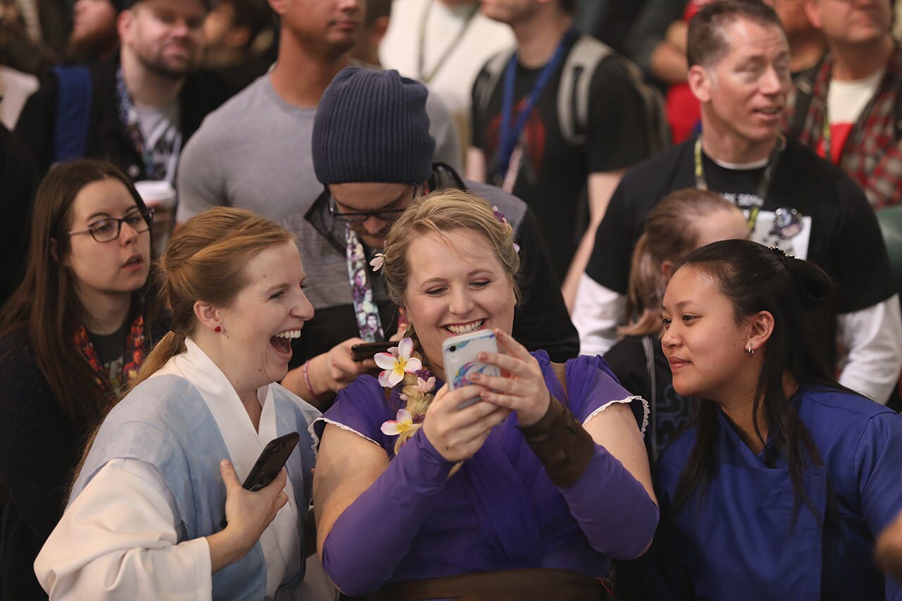 Fans checking their phone in a crowd at Star Wars Celebration 2019