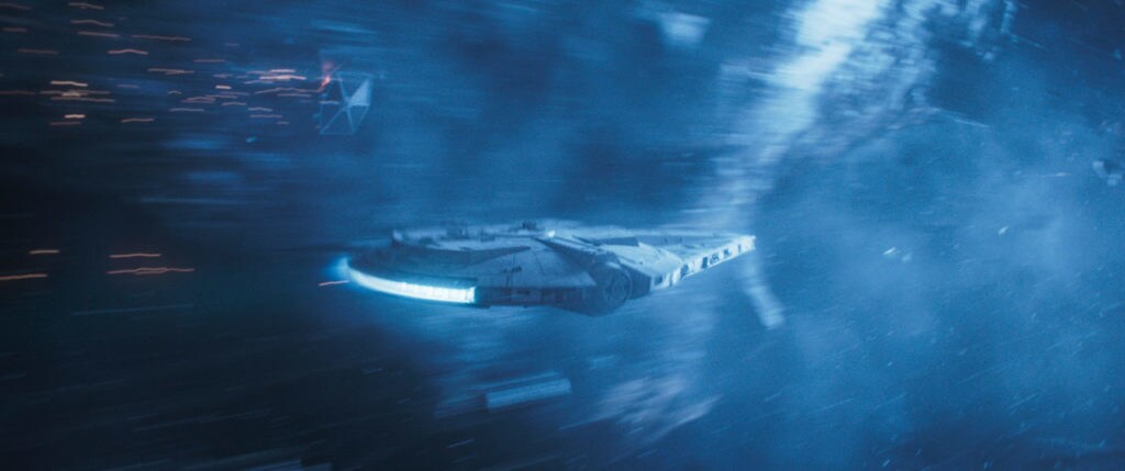The Millennium Falcon flees from a group of TIE fighters in Solo: A Star Wars Story.