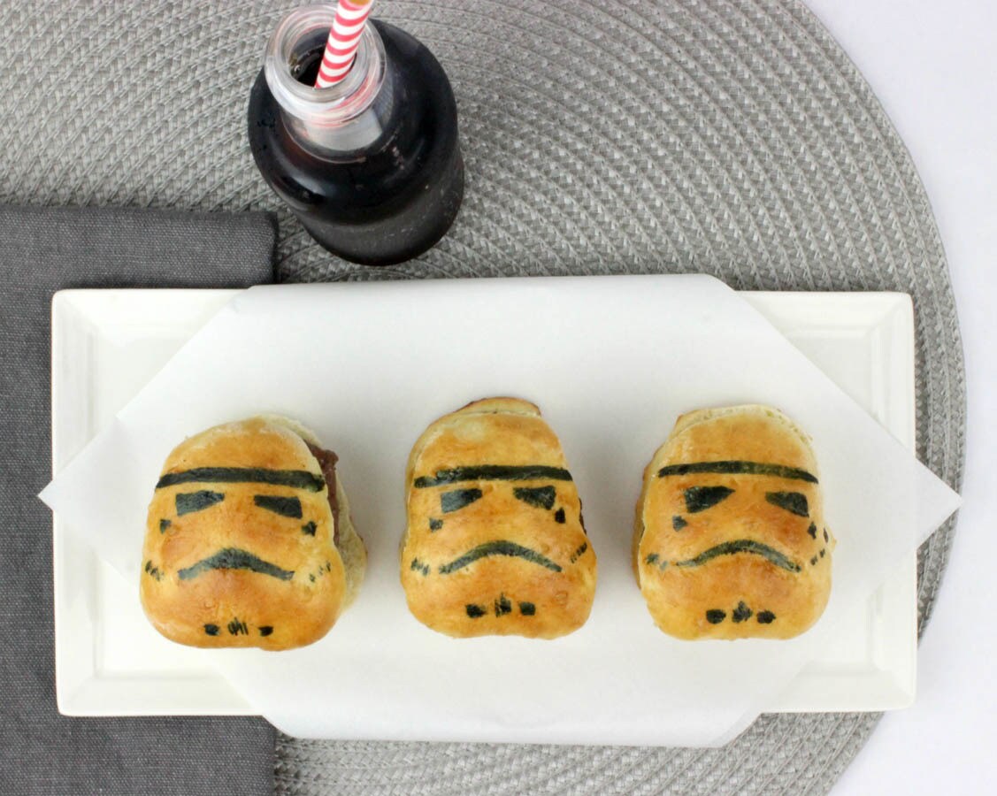 Three completed Stormtrooper Sliders on a plate next to a soda bottle with a striped straw inside.