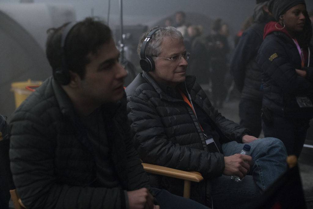 Writers Jonathan and Lawrence Kasdan watch filming on set.