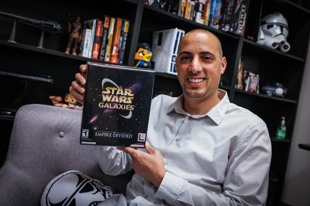 A member of the Lucasfilm Games Team holds up the box of Star Wars Galaxies.