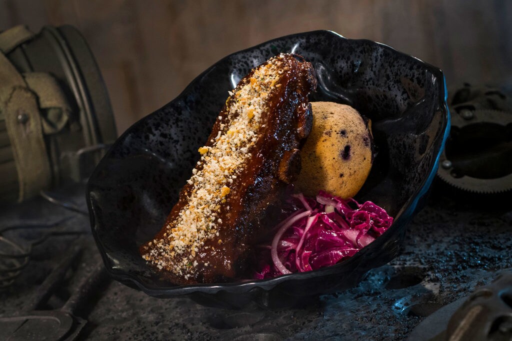 The Smoked Kaadu Ribs, found at Docking Bay 7 Food and Cargo inside Star Wars: Galaxy’s Edge, features smoked country sticky pork ribs with blueberry corn muffin and cabbage slaw. (David Roark/Disney Parks)
