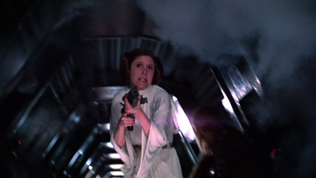 Princess Leia shoots at stormtroopers onboard the Death Star.