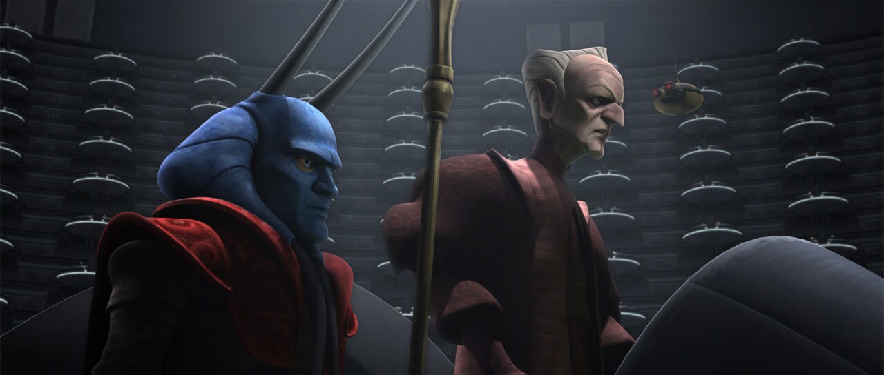 Mas Amedda stands next to Palpatine in a pod at the center of the Galactic Senate Chamber in The Clone Wars.