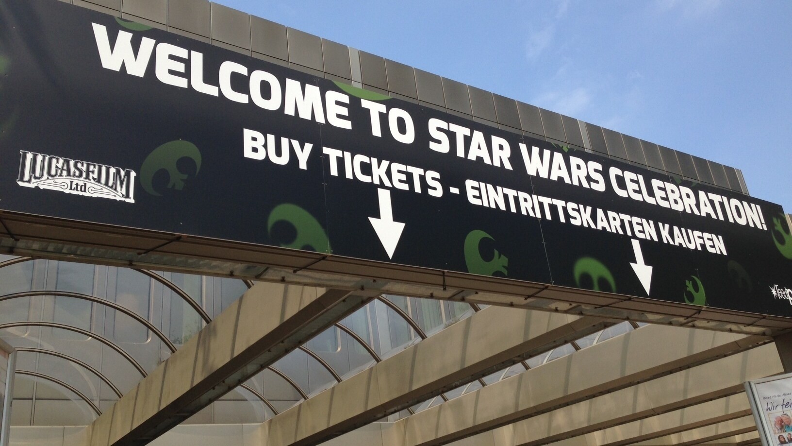 A sign at Star Wars Celebration Europe 2013 reads &quot;Welcome to Star Wars Celebration”. It says “Buy Tickets” in English and German.