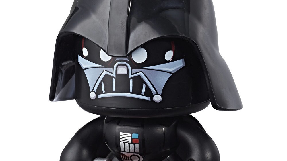 A Darth Vader Star Wars Mighty Muggs collectible figure holds a lightsaber with an angry look on its face.