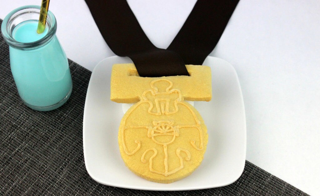 A top-down shot of a plated Medallion of Yavin cookie and a jar of blue milk
