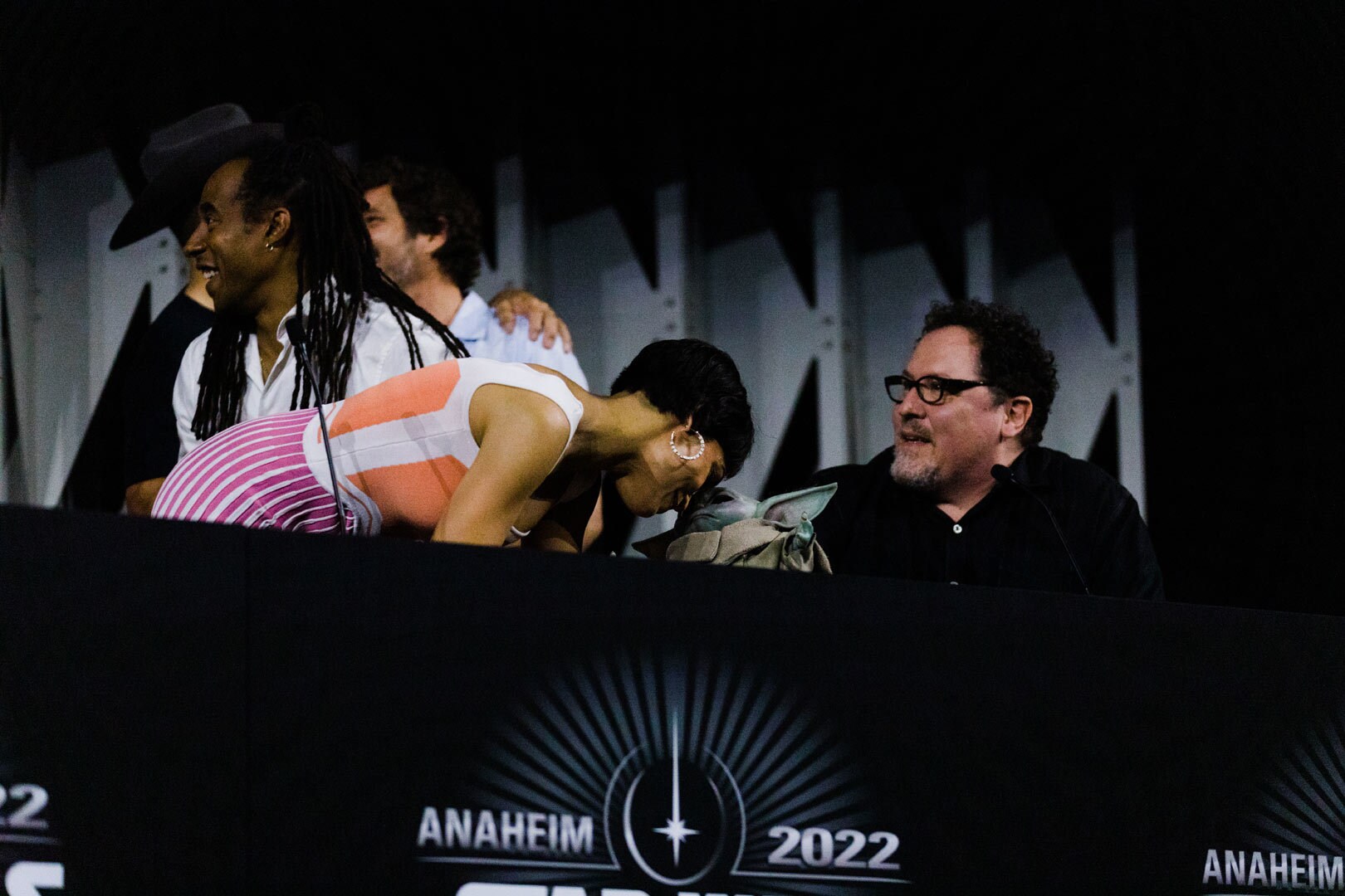 Rosario Dawson and Grogu touching foreheads at the Mando+ panel