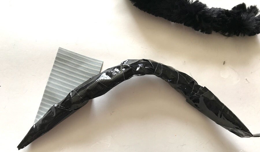 Duct tape wrapped around a bent pipe cleaner.