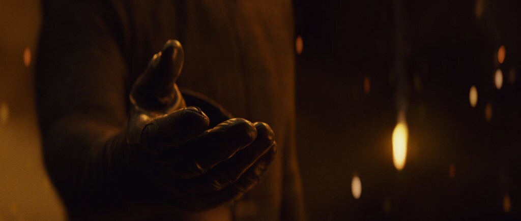 An outreached hand in a black glove from Star Wars: The Last Jedi.