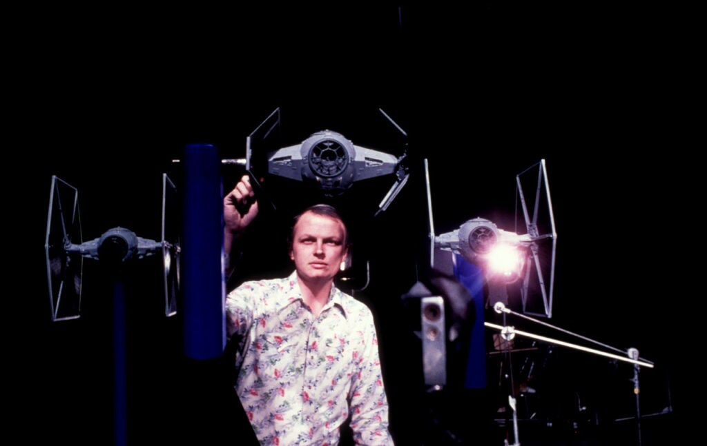 Visual effects artist Dennis Muren arranges a group of model TIE fighters.