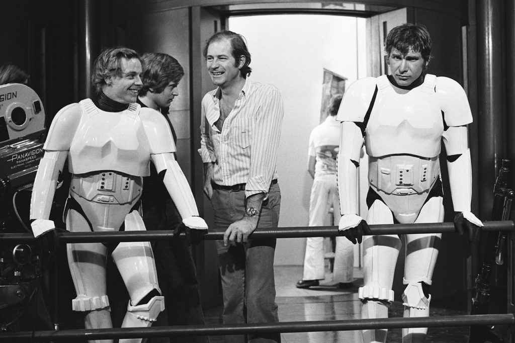 Mark Hamill and Harrison Ford take a break in their stormtrooper costumes between filming scenes for Star Wars: A New Hope.