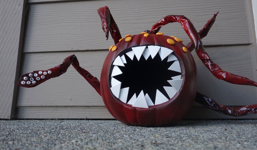 A pumpkin painted red and decorated with tentacles and teeth to look like a rathtar.