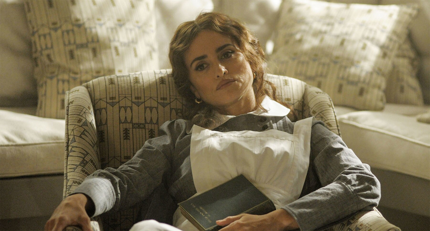 Penélope Cruz (as Pilar Estravados) sitting on a chair in "Murder on the Orient Express"