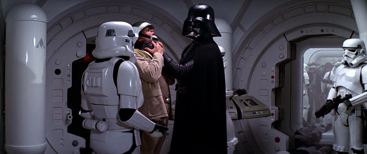 Darth Vader chokes Captain Antilles while stormtroopers stand nearby aboard the Tantive IV.