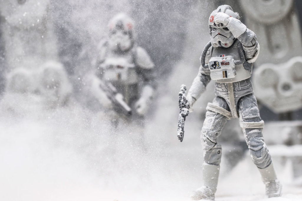 Toy stormtroopers posed in the snow.