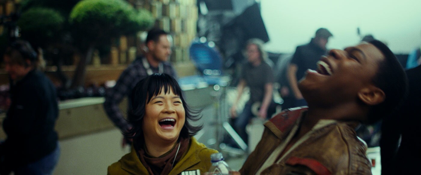 Kelly Marie Tran and John Boyega laugh on the set of The Last Jedi.