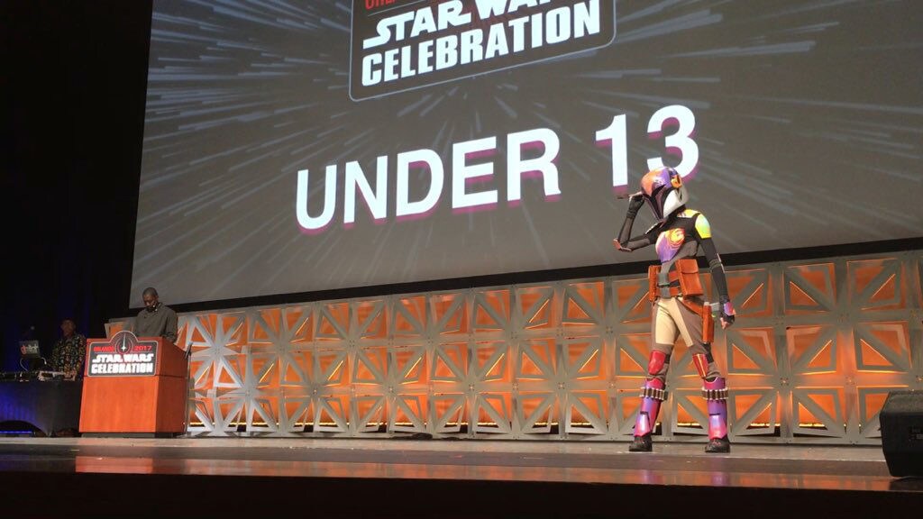 A Sabine Wren cosplayer wears homemade Mandalorian armor.