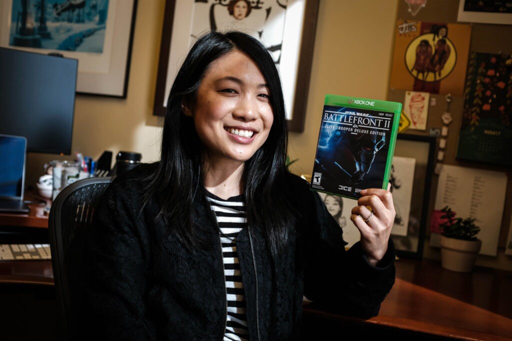 A member of the Lucasfilm Games Team holds up the box of Star Wars Battlefront II.