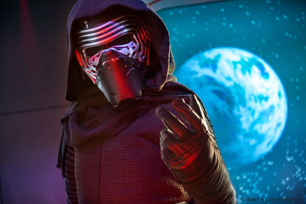 Kylo Ren, masked, gestures threateningly.