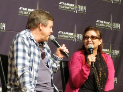 Actors Mark Hamill and Carrie Fisher sit beside one another on stage at the Star Wars Celebration Europe Kickoff Press Conference.