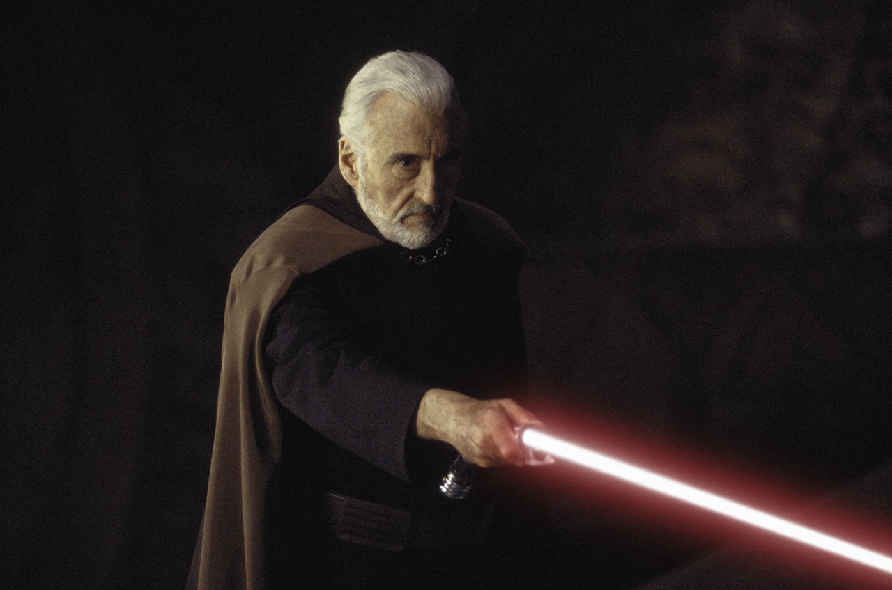 Count Dooku holding his lightsaber