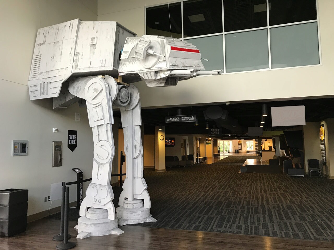 A 17-foot tall AT-AT, created by a Star Wars fan, protrudes from a wall.