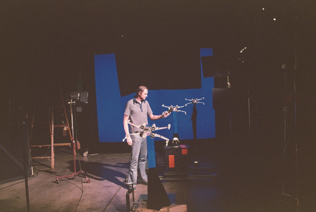 Visual effects artist Dennis Muren arranges a group of model X-Wing starfighters.