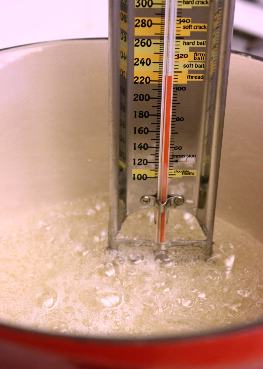 A candy thermometer measures the temperature of a mixture of sugar and water.