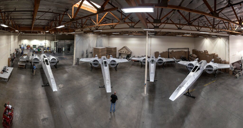 A fleet of X-wings in production at a warehouse for Disney's Star Wars: Galaxy's Edge.
