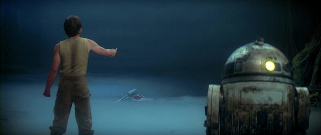 Luke tries to raise the X-wing from the swamp as R2-D2 watches in Star Wars: The Empire Strikes Back.
