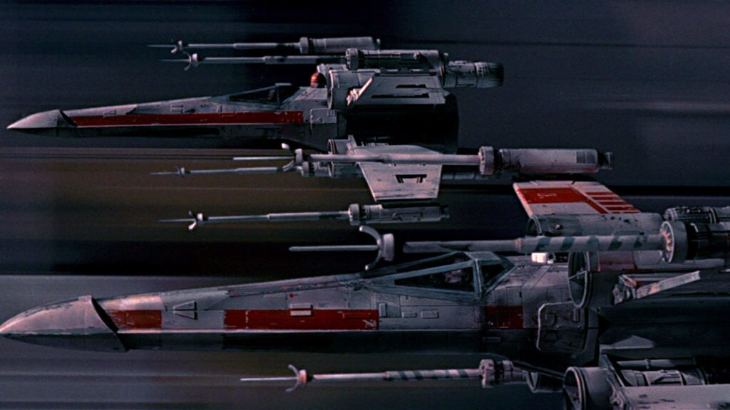 X-wings fly through the Death Star trench.