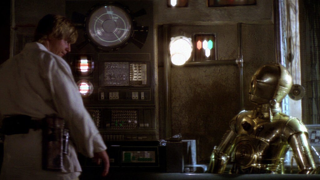 Luke talks to C-3PO who is waist-deep in an oil bath in A New Hope.