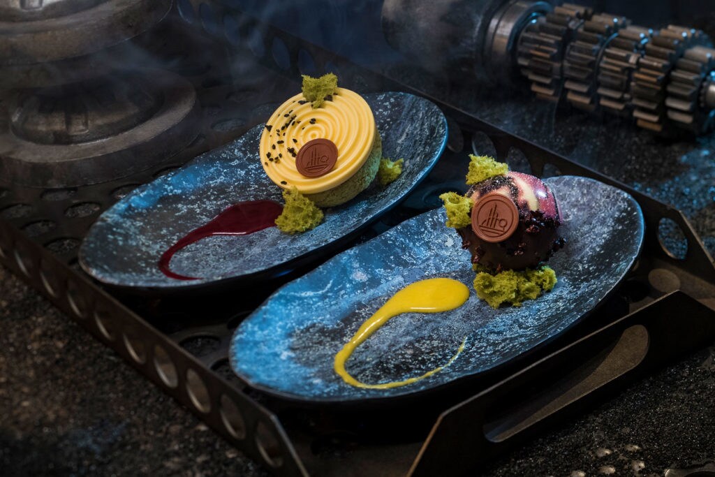 Guests can indulge in a raspberry crème puff with passion fruit mousse (left) or chocolate cake with white chocolate mouse and coffee custard (right) at Docking Bay 7 Food and Cargo inside Star Wars: Galaxy’s Edge. (David Roark/Disney Parks)