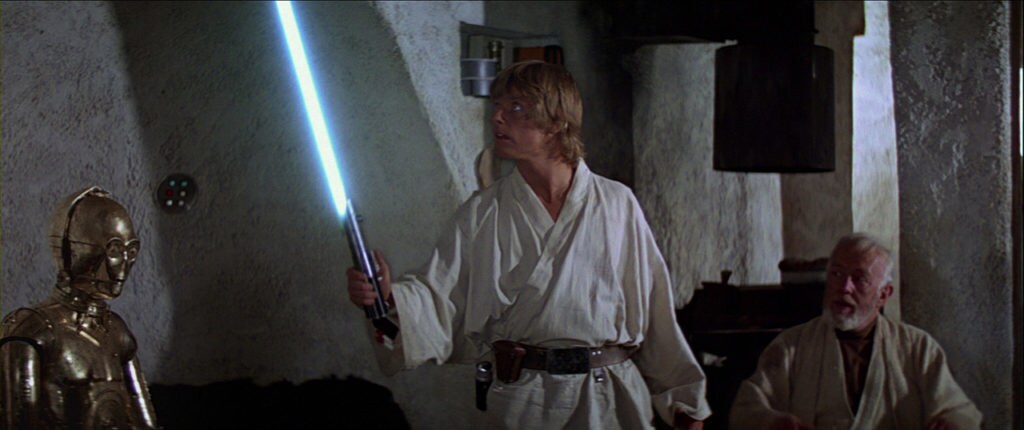 Luke tries using a lightsaberfor the first time while Obi-Wan looks on and C-3PO sits in A New Hope.