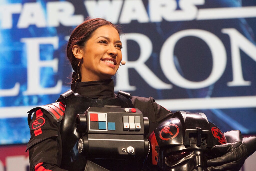 Janina Gavankar smiles in her Iden Versio costume.