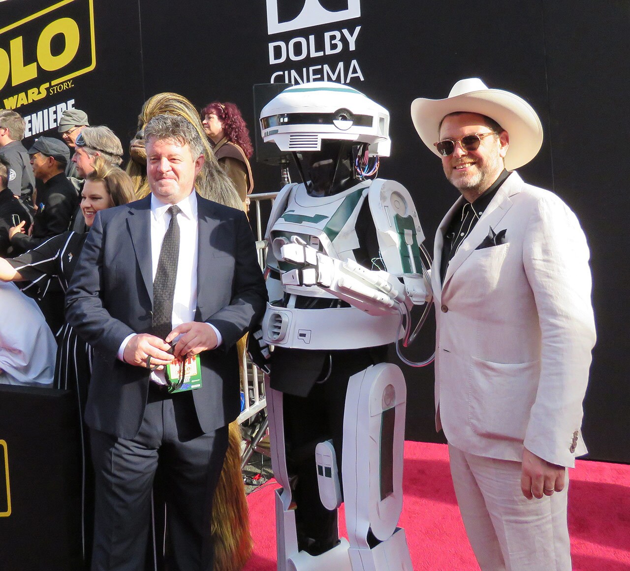 Costume designers David Crossman, left, and Glyn Dillon, right, stop to pose with cosplayer Darren Moser, dressed as L3-37, during the world premiere of <em>Solo: A Star Wars Story</em>.