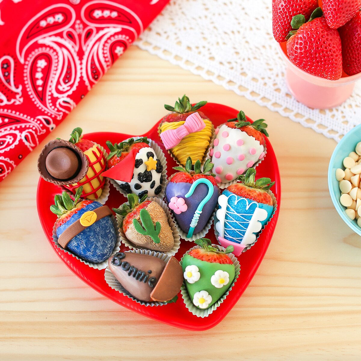 Several chocolate covered strawberries inspired by Toy Story 4 in a heart shaped plate.