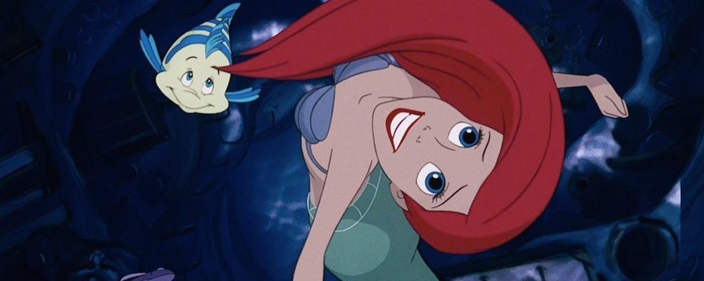 Ariel smiles and swims with Flounder.