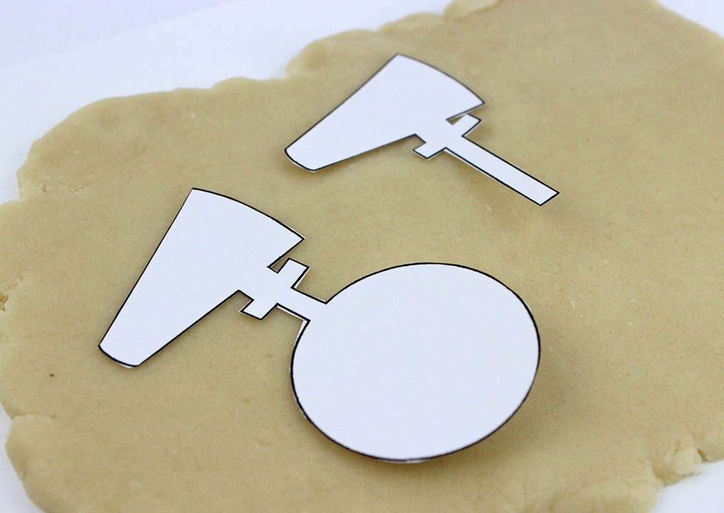 A D-O cookie template cut out and placed atop flattened cookie dough.