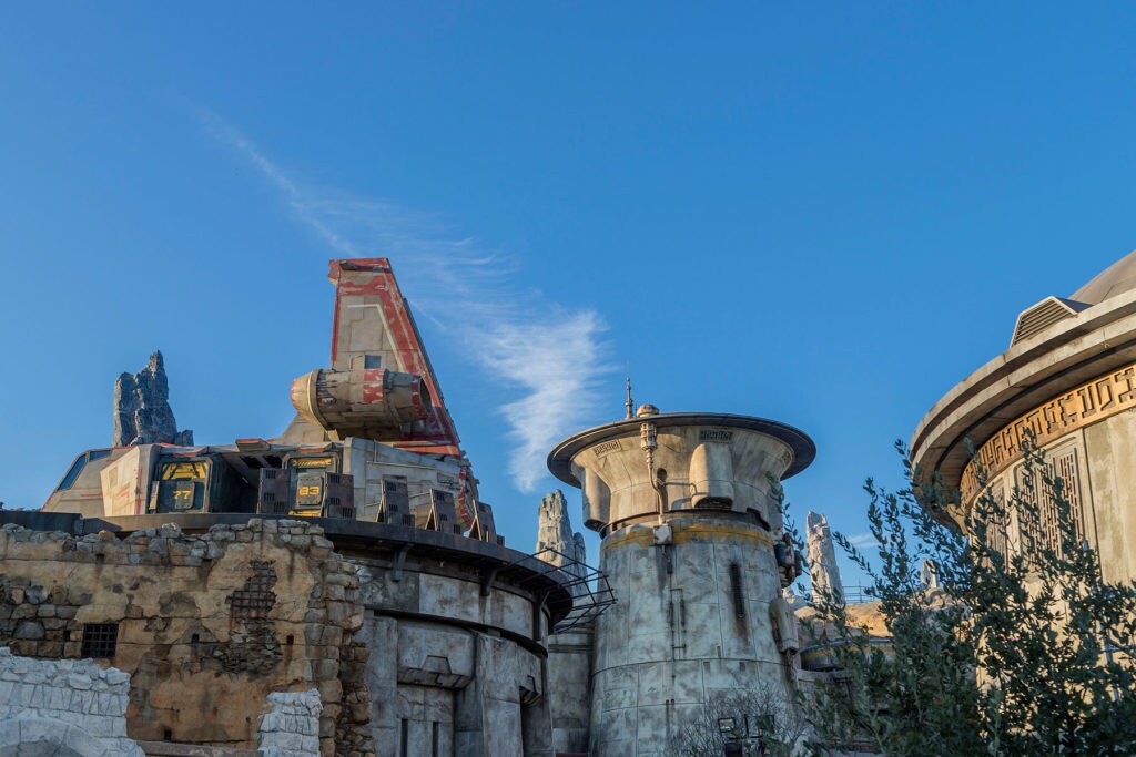 A outside view of Disney's Star Wars: Galaxy's Edge shows the Sienar-Chall Utilipede Transport Ship in its dock.